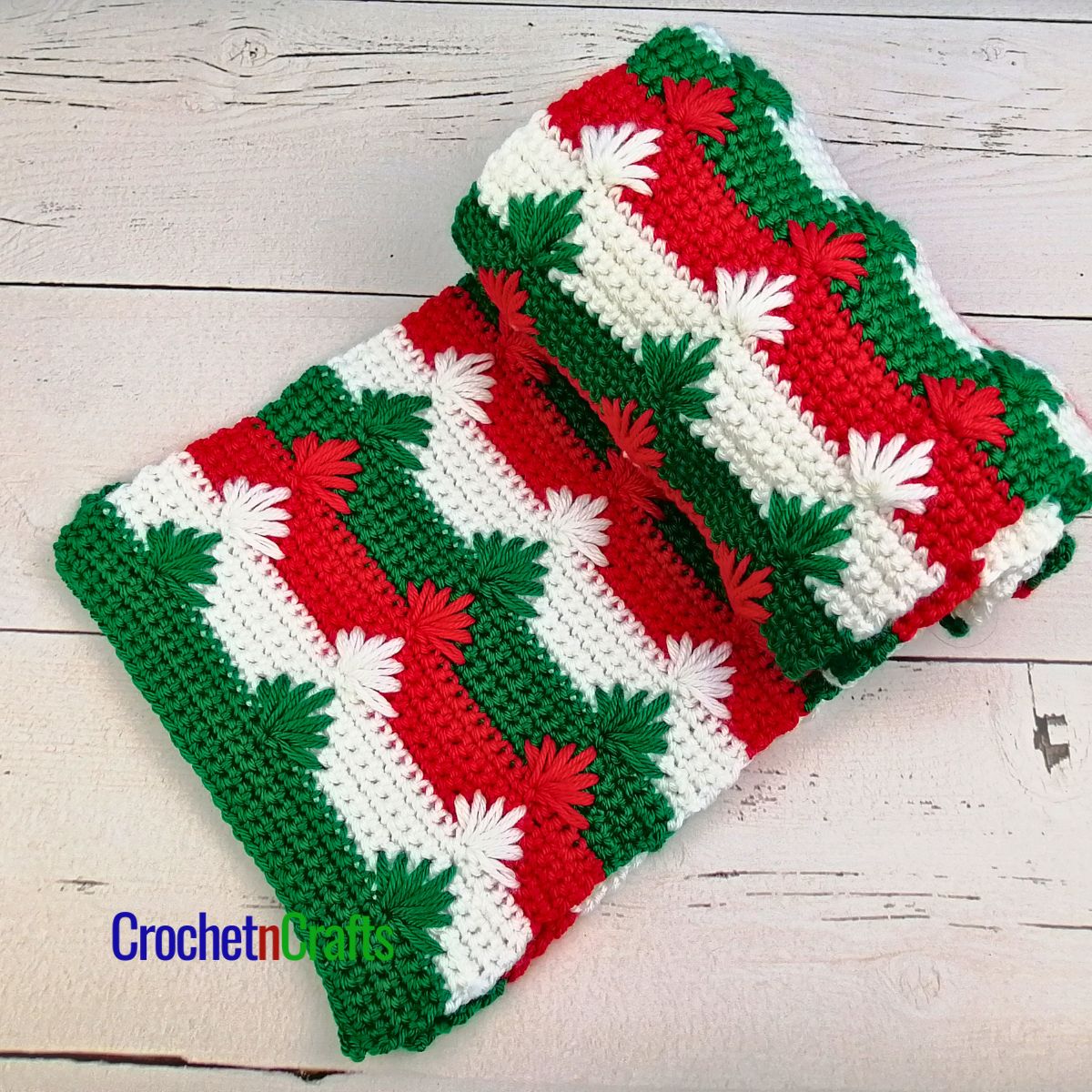 A Christmas crochet scarf rolled up.