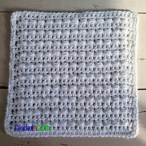 A crocheted dishcloth or hotpad worked up in the horizontal puff stitch using Bernat Handicrafter Cotton.
