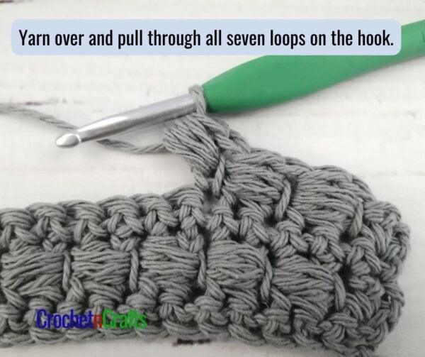 Yarn over and pull through all seven loops on the hook to complete the puff stitch.