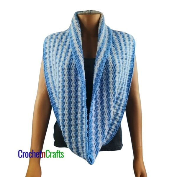 A crocheted cowl worn long like a scarf.