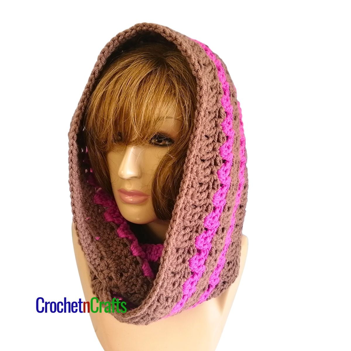 A striped crocheted cowl worn as a hooded cowl.