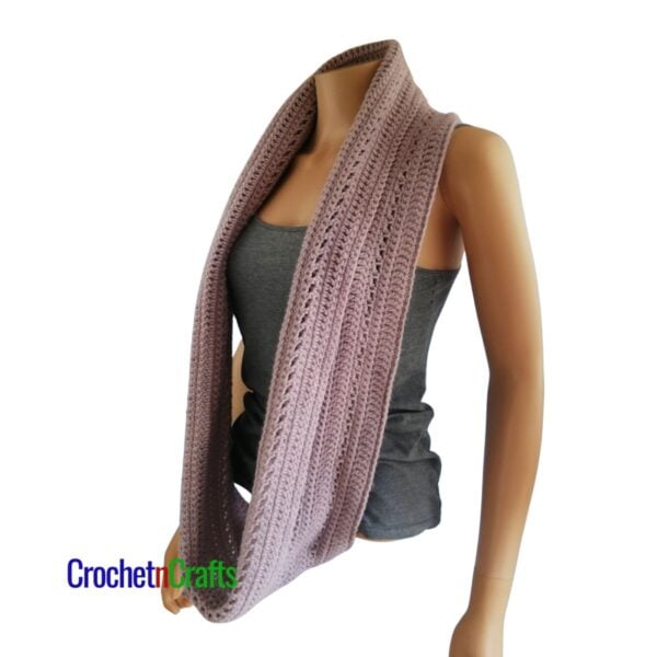 A crocheted cowl worn long like a scarf.