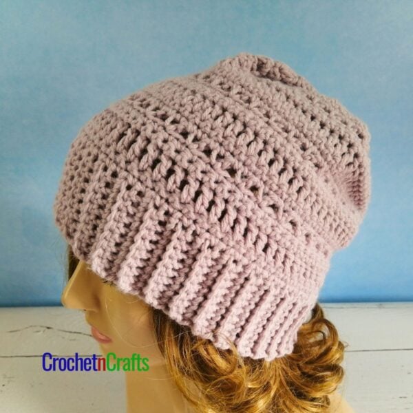 A simple crochet hat shown on a mannequin.