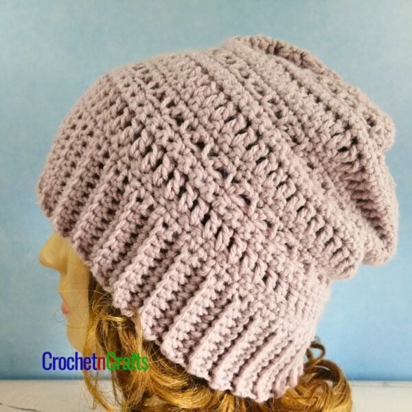 A simple crocheted hat shown on a mannequin.