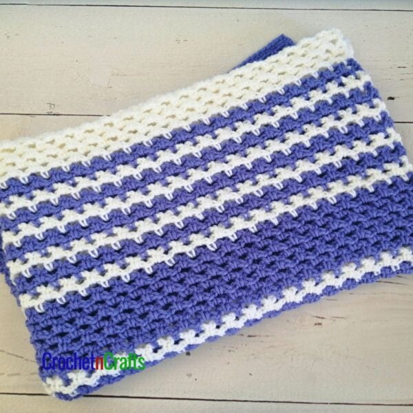 A striped mesh blanket is folded up.