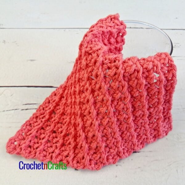 Groovy Crochet Washcloth Draped Over a Glass