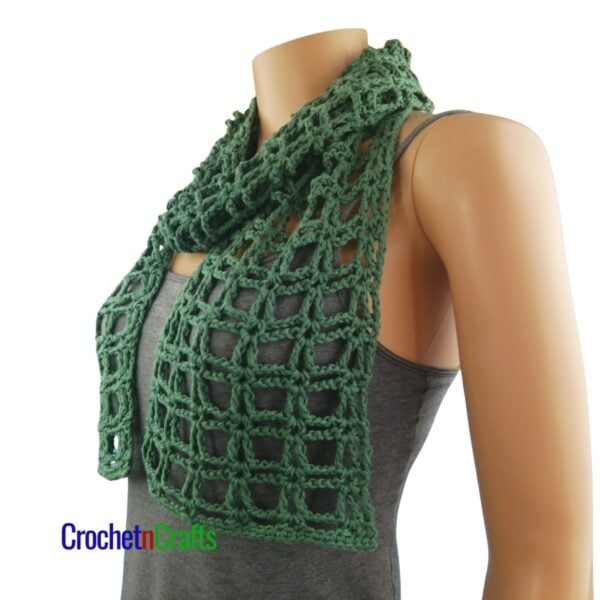 A light summer crochet scarf wrapped loosely around the neck. - Side View.