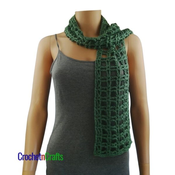 A light summer crochet scarf draped over the shoulders.