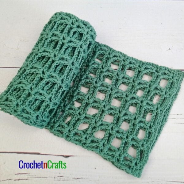A light summer crochet scarf rolled up.