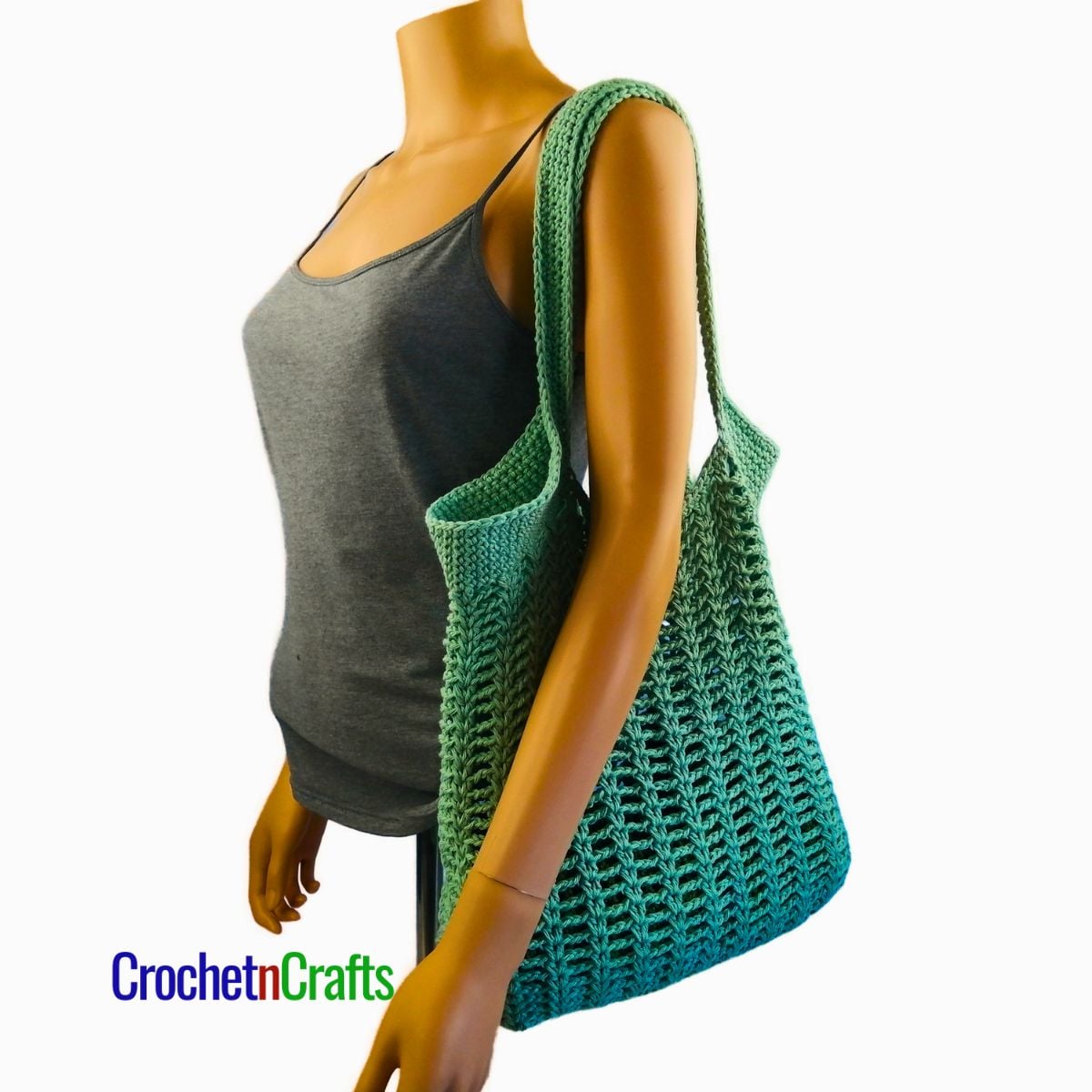 Pretty Simple Chains Crocheted Shoulder Bag Over the Shoulder of a Mannequin.