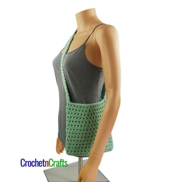 Crochet messenger worn across the body - shown from the side.